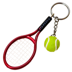 A novelty tennis racket keychain featuring a red tennis racket head with white strings, a black wrapped grip, a silver split ring, a short chain, and a small yellow-green tennis ball charm with white lines, shown on a plain white background.