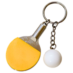A miniature table tennis keychain charm, featuring a yellow and black paddle with a small white ball and silver metal key ring on white background.