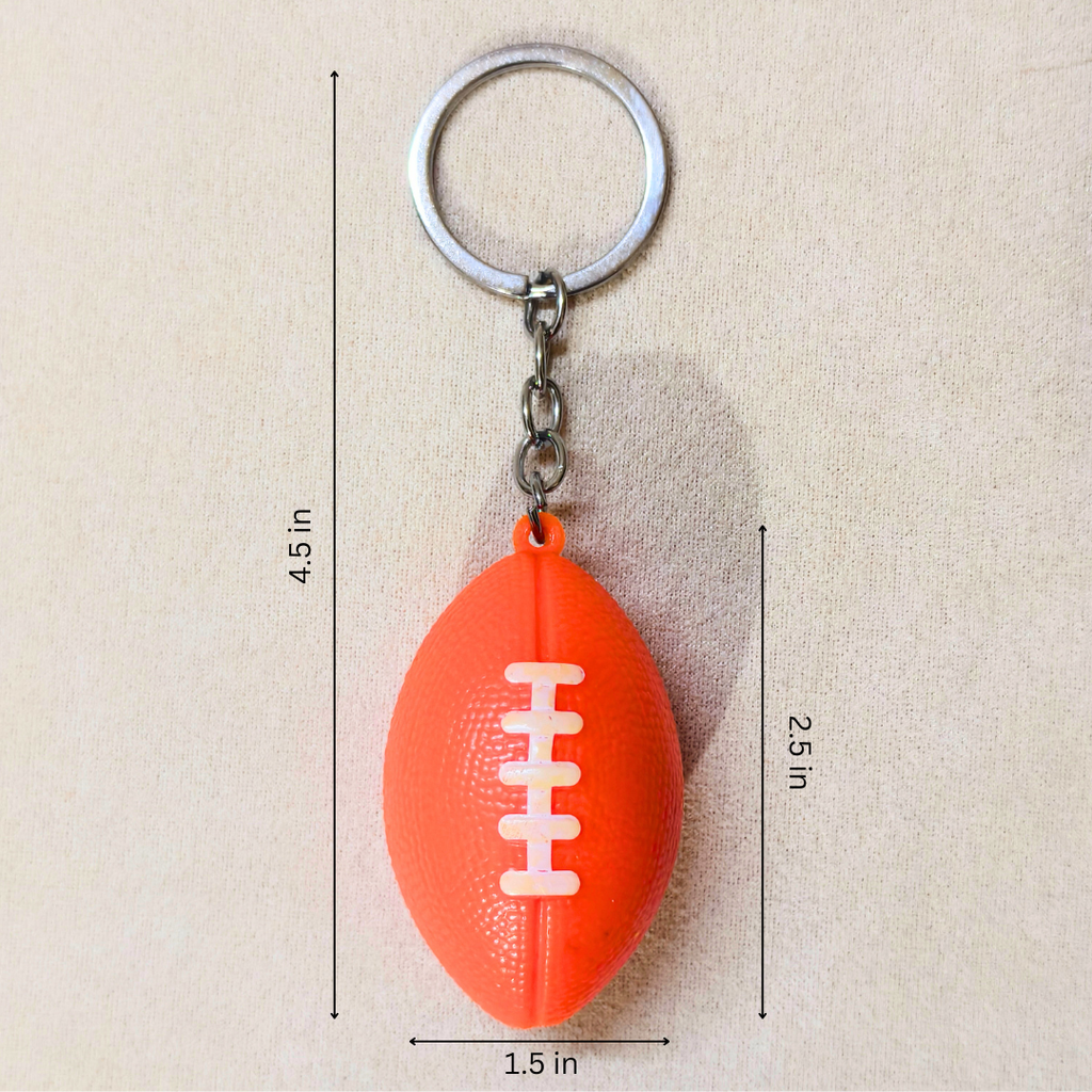 An orange football-shaped keychain with a silver metal key ring and chain, shown on a beige background with dimension lines indicating measurements of 4.5 inches in height, 2.