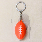 An orange football-shaped keychain with a silver metal key ring and chain, shown on a beige background with dimension lines indicating measurements of 4.5 inches in height, 2.