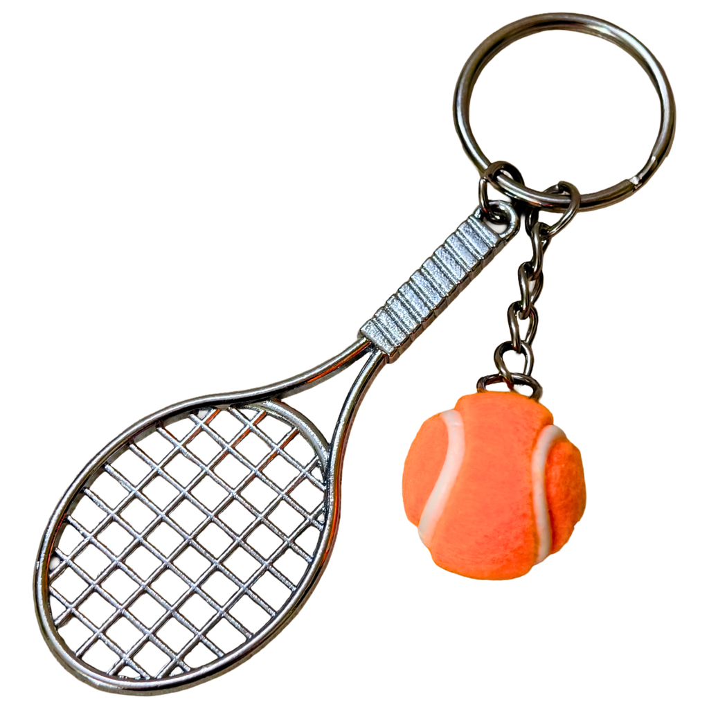 A novelty keychain featuring a silver metal tennis racket and a small orange tennis ball charm with a white seam, attached to a split ring on a plain white background.