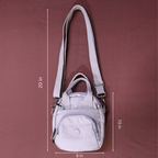 Gray handbag with measurements on a maroon background
