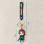 Keychain with character figure and 'Demon Slayer' branding, shown with measurements on a beige background.