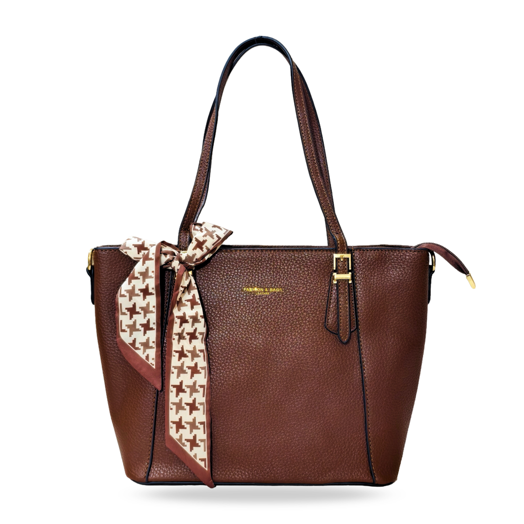 Brown handbag with a patterned scarf tied around it on a white background
