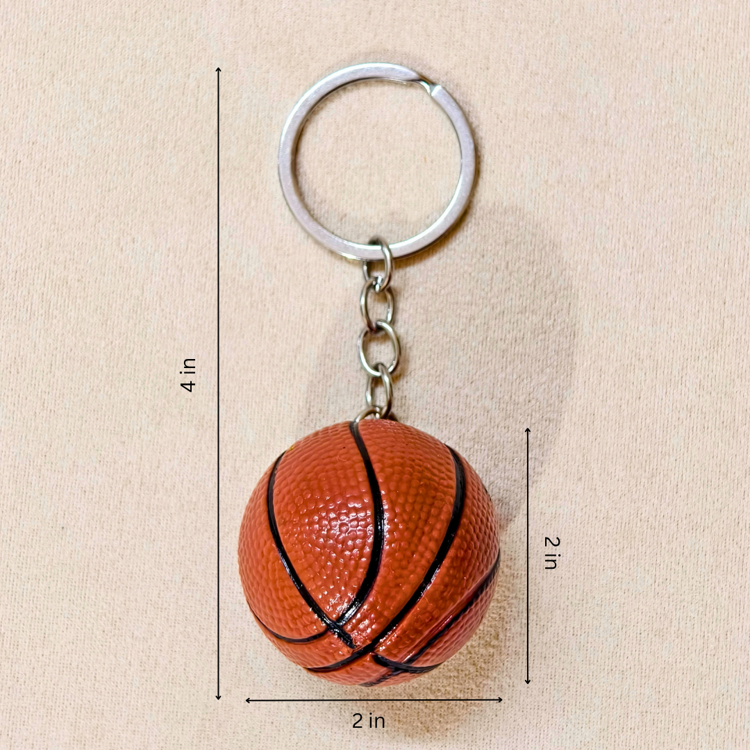 A miniature basketball-shaped keychain showing measurements against a plain beige background.