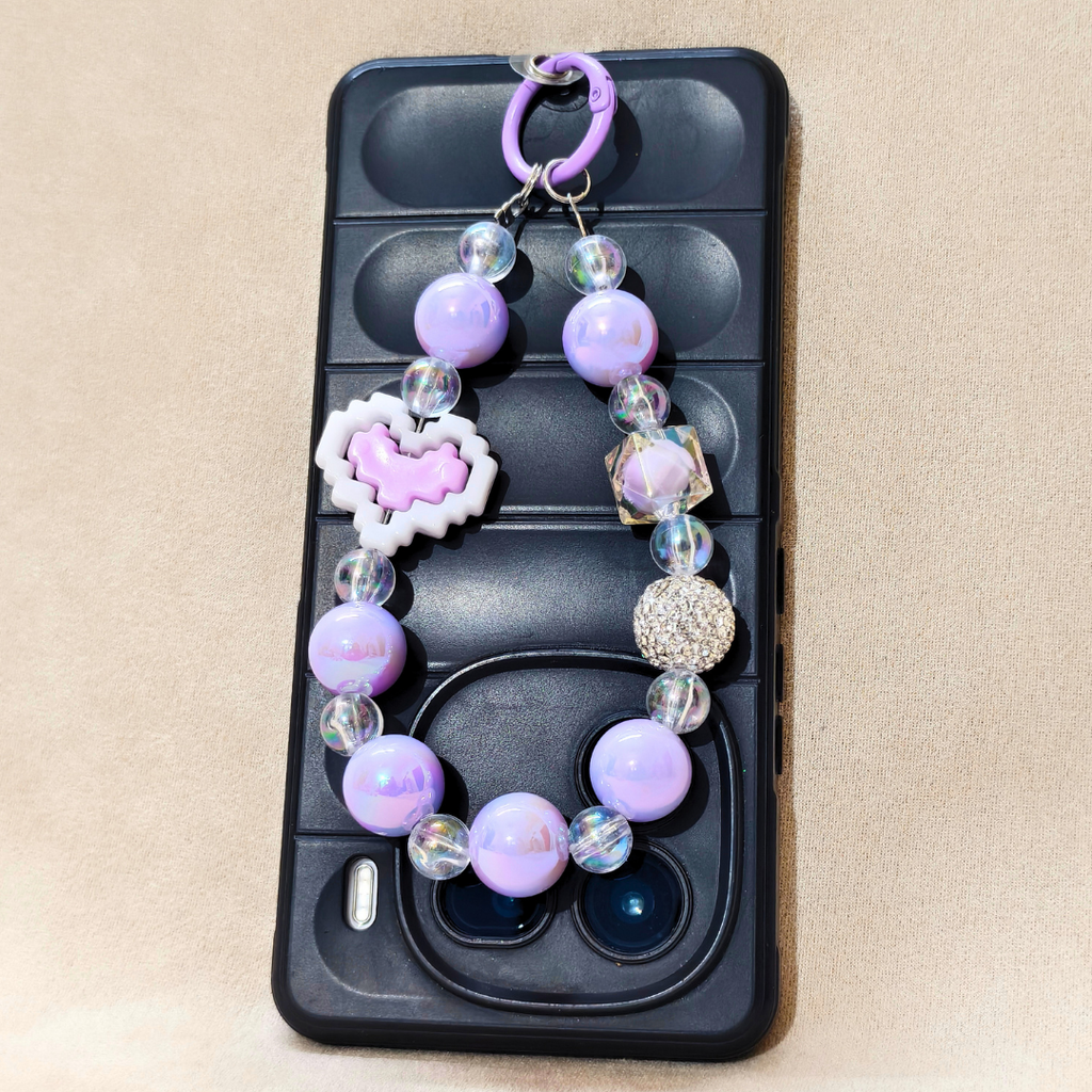 Phone case with a decorative bead chain on a beige background