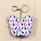 A butterfly-shaped compact mirror keychain with a white background and a colorful lipstick and lip print, shown with dimension markings of 3.5 inches by 5 inches on a beige background.