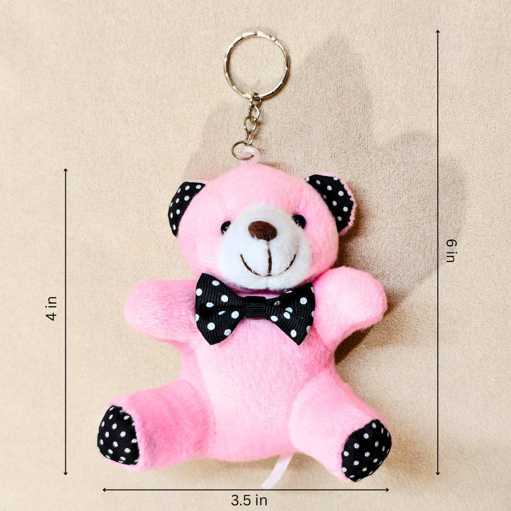 Pink plush teddy bear keychain with black polka-dot ears, bow tie, and paw pads, shown on a beige background with dimension lines indicating 4 in height, 6 in overall height, and 3.5 in width.