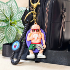 Master Roshi Keyring Attached With Purse As  Bag Charm On  Beige Background.