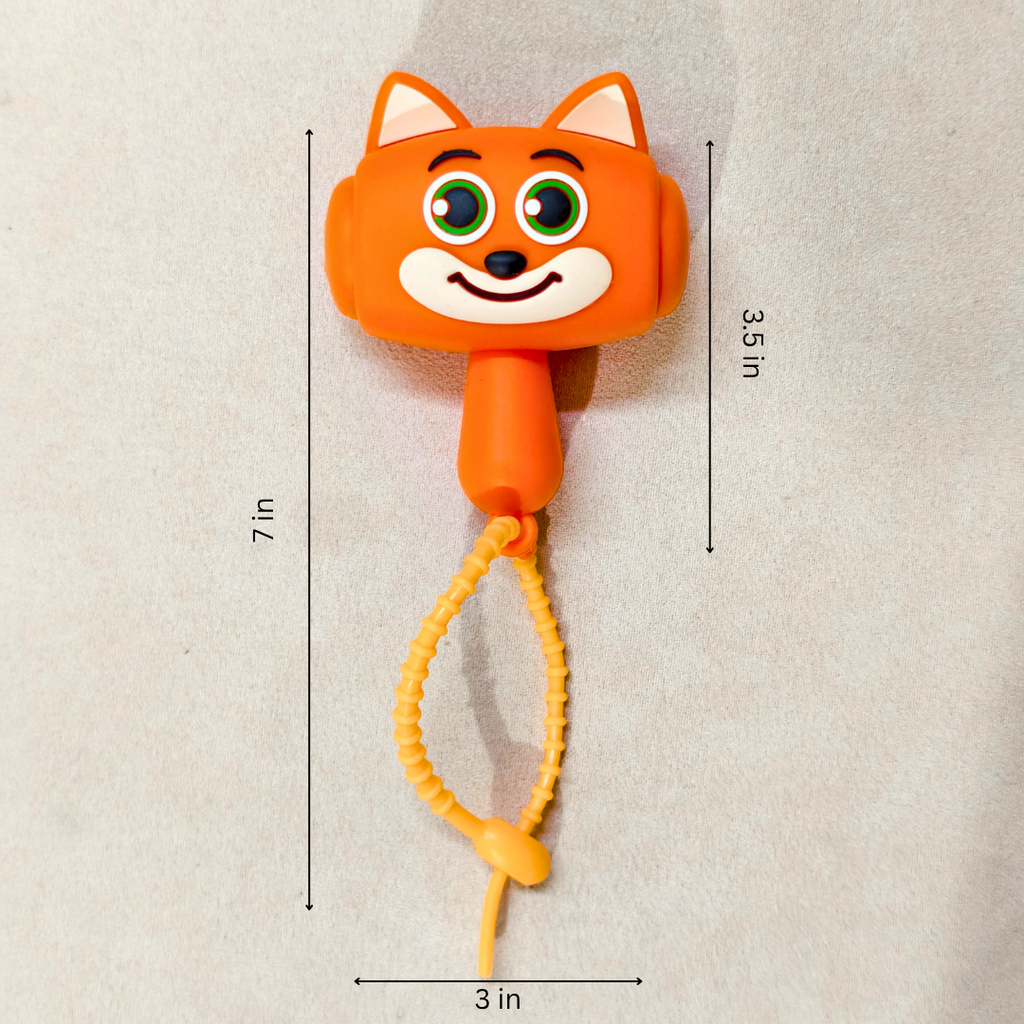 An orange fox-shaped phone accessory with a coiled yellow cord, shown on a light beige background with dimension lines indicating 7 in height, 3.5 in width, and 3 in depth.