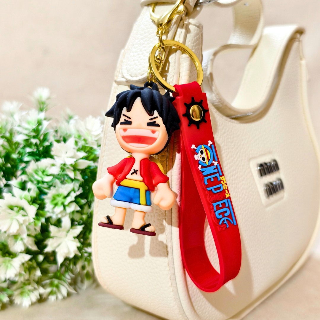 Keychain with cartoon character and red strap on a beige bag with flowers in the background
