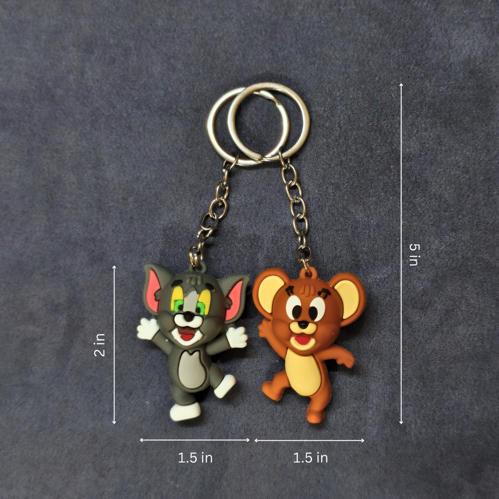 Two cartoon character keychains on a dark gray background with measurements indicated.