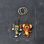 Two cartoon character keychains on a dark gray background with measurements indicated.