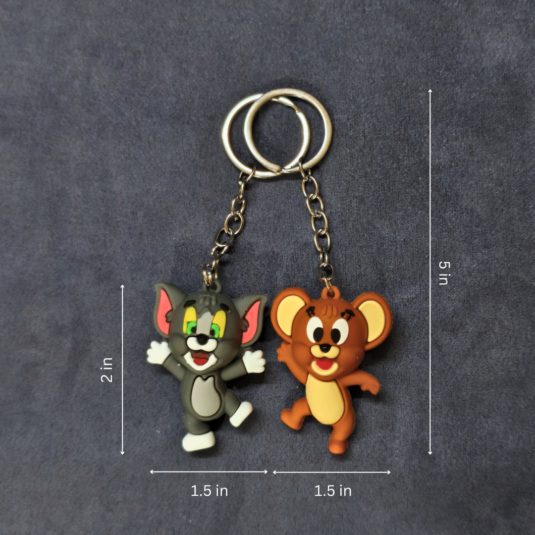 Two cartoon character keychains on a dark gray background with measurements indicated.