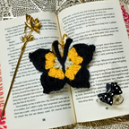 Butterfly-shaped earrings on an open book