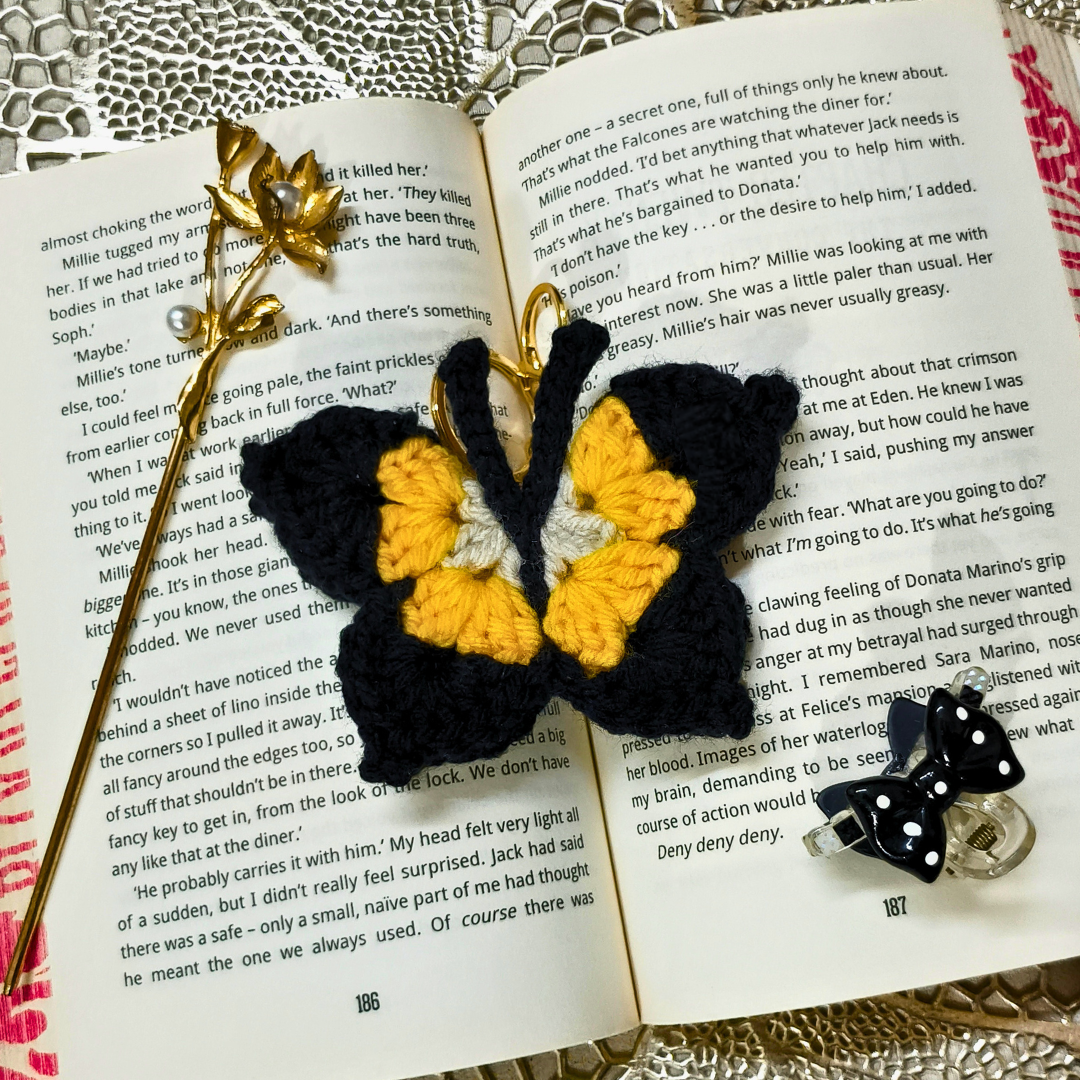 Butterfly-shaped earrings on an open book