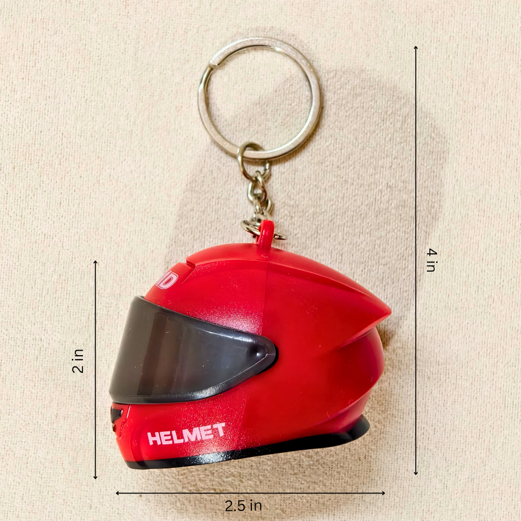 A red miniature helmet keychain with a silver metal key ring, shown with dimension lines indicating its height, width, and depth on a beige textured background.