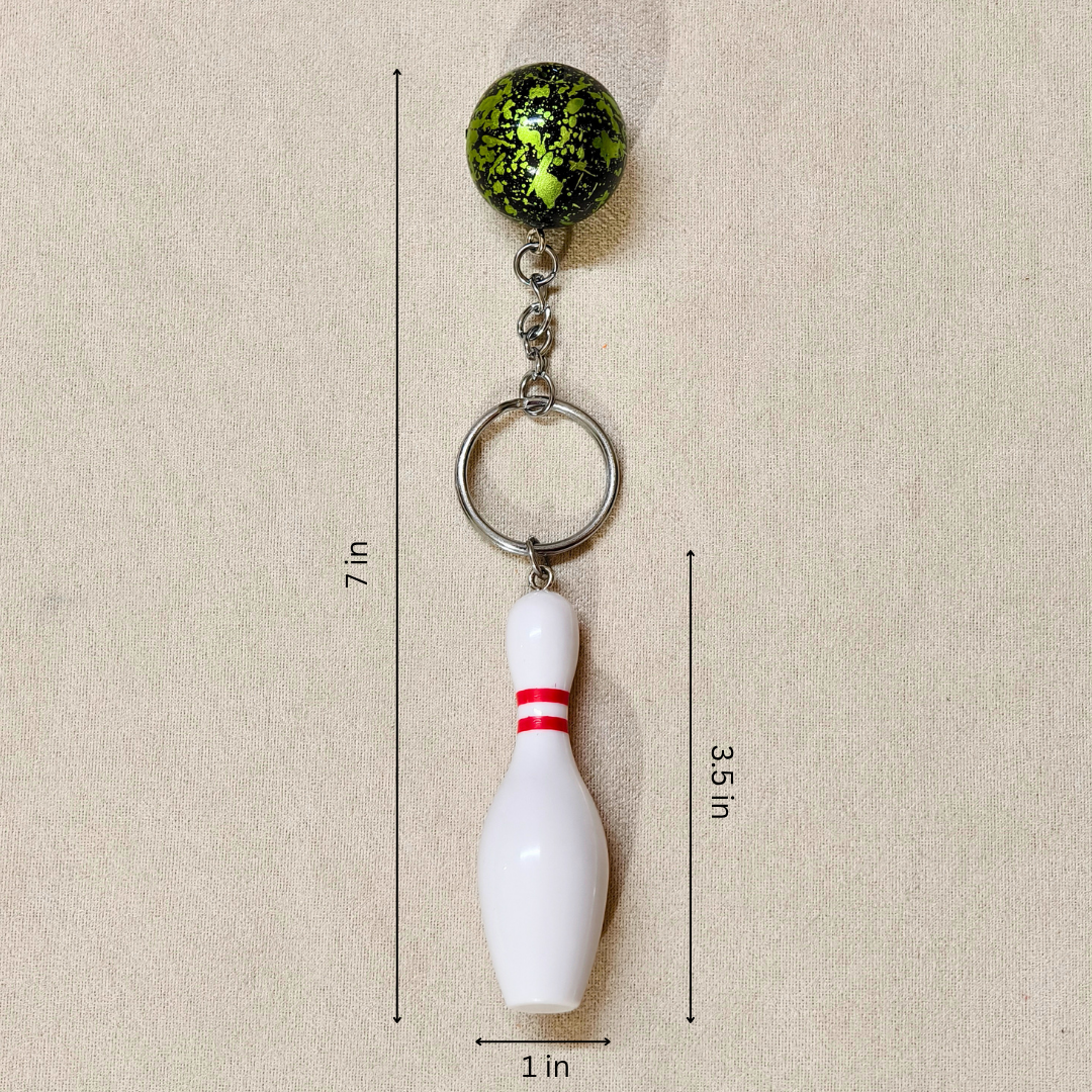 A novelty bowling keychain showing measurements, featuring a green and black mottled bowling ball and a white bowling pin with a red stripe, attached to a silver split ring.

Details