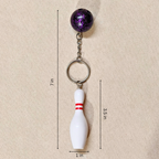 Sporty Bowling Keychain along with Silver chain and ring with Ball  showing measurements on Beige Background.