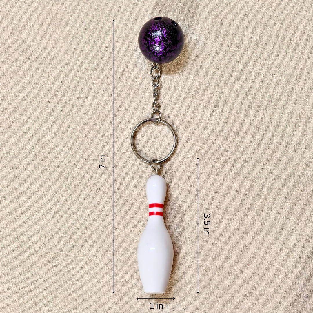 Sporty Bowling Keychain along with Silver chain and ring with Ball  showing measurements on Beige Background.