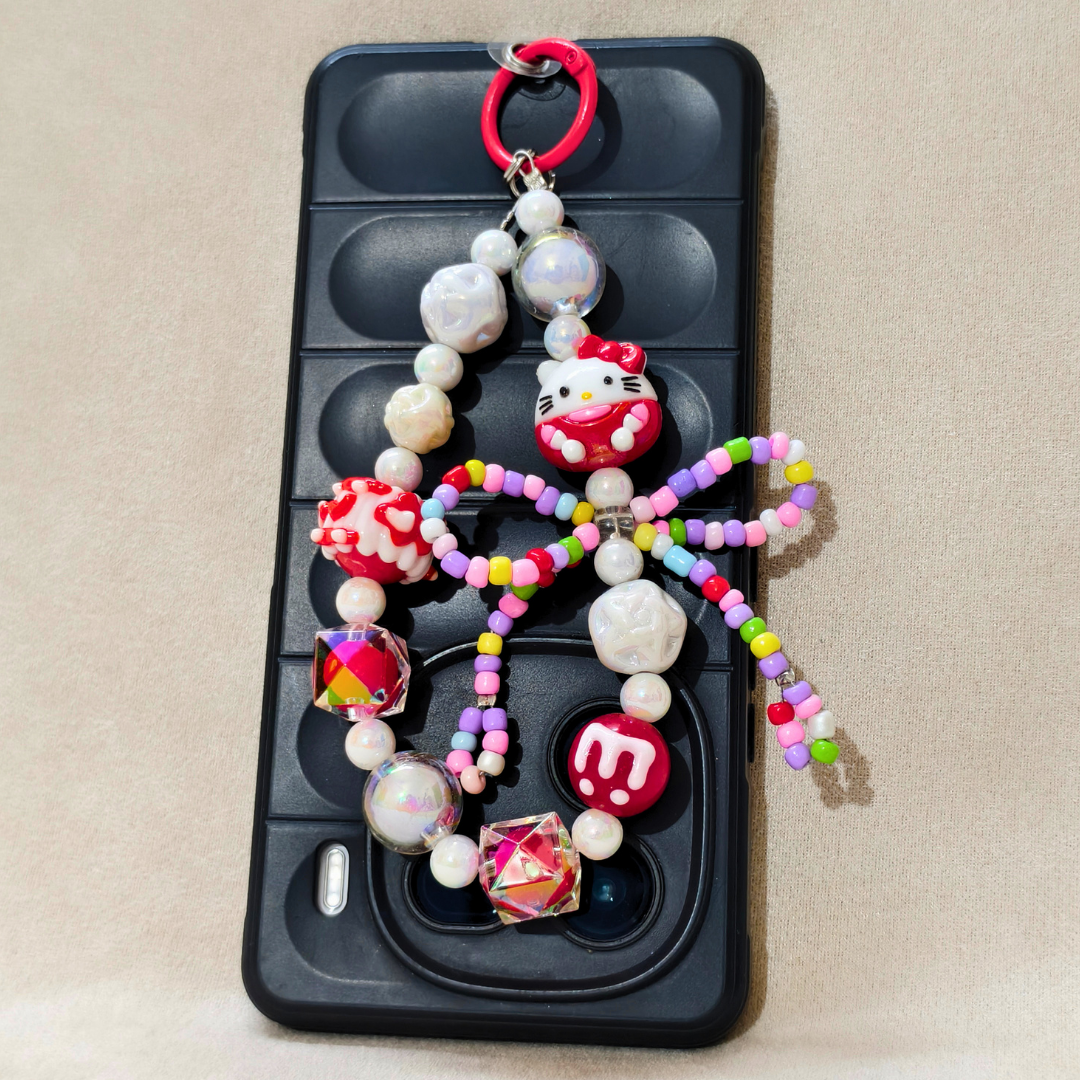 Phone case with colorful beaded charm featuring a character on a beige background