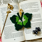 Crocheted butterfly keychains on an open book