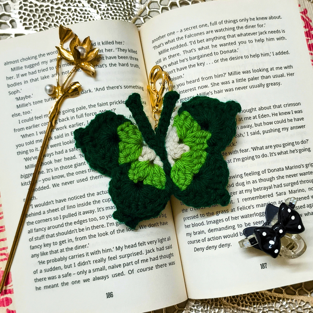 Crocheted butterfly keychains on an open book