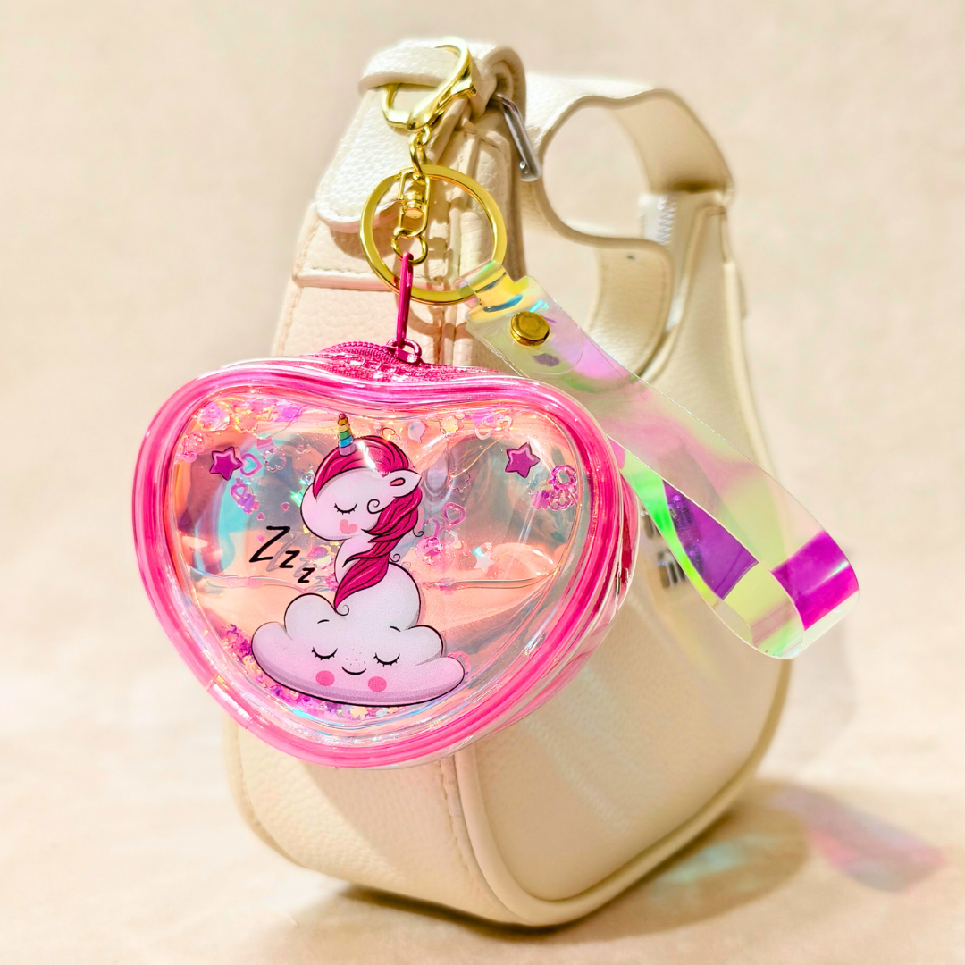 Heart-shaped keychain with a cartoon design on a beige handbag.