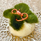 White Key Chain On Top Of Golden Mat.