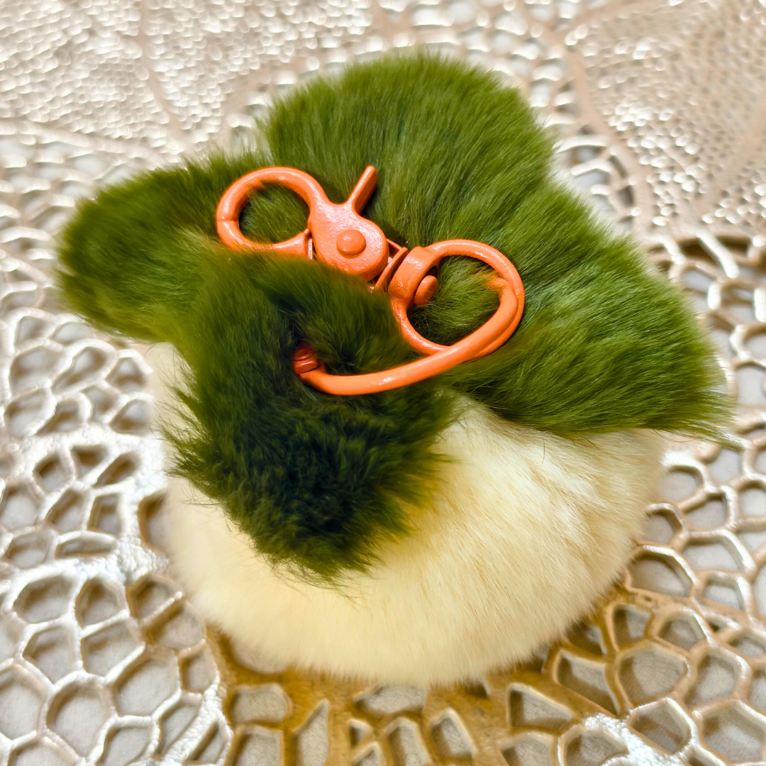White Key Chain On Top Of Golden Mat.