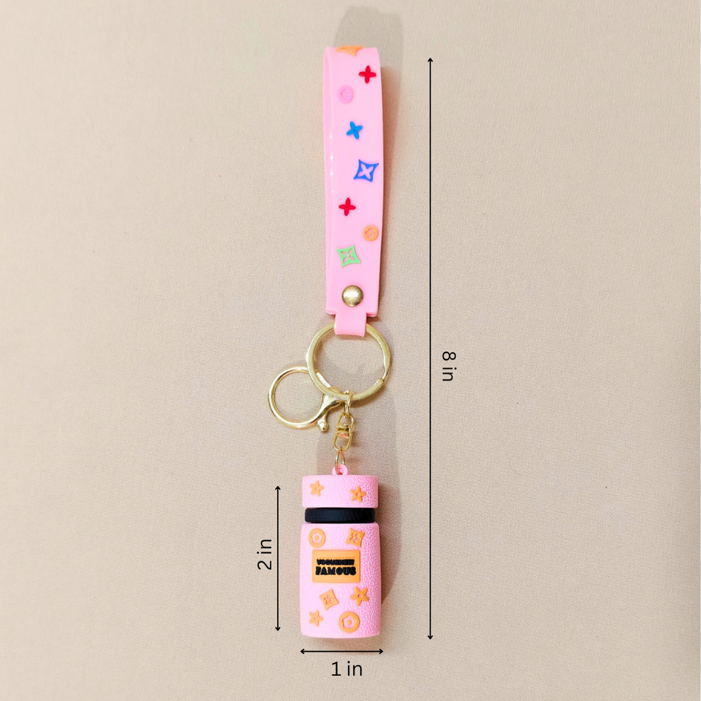 Pink keychain with colorful accents and dimensions on a beige background