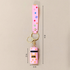 Pink keychain with colorful accents and dimensions on a beige background