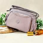 Lavender Lilac Sling Bag With Props In Front Of Beige Background.