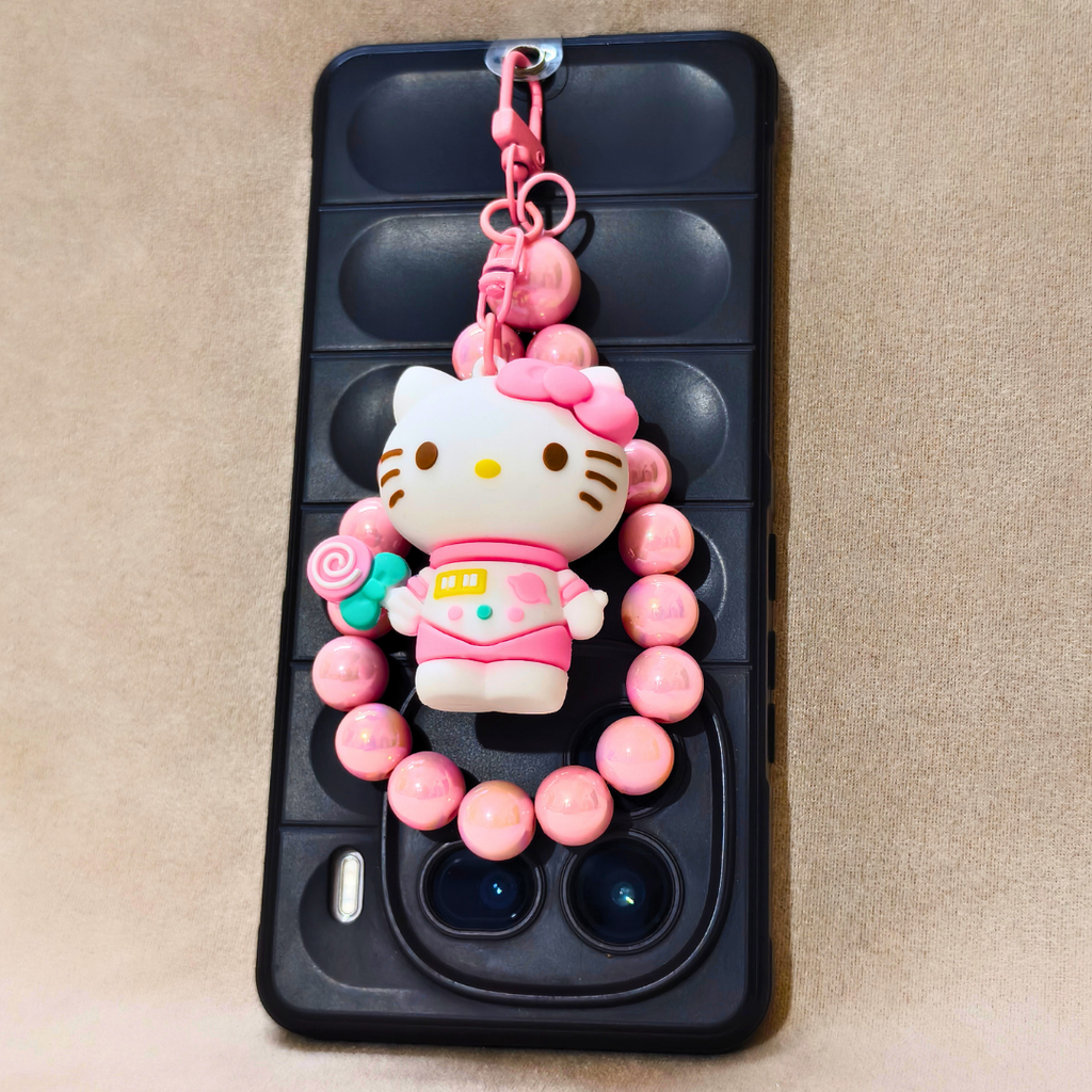 Phone case with a Hello Kitty charm on a beige background