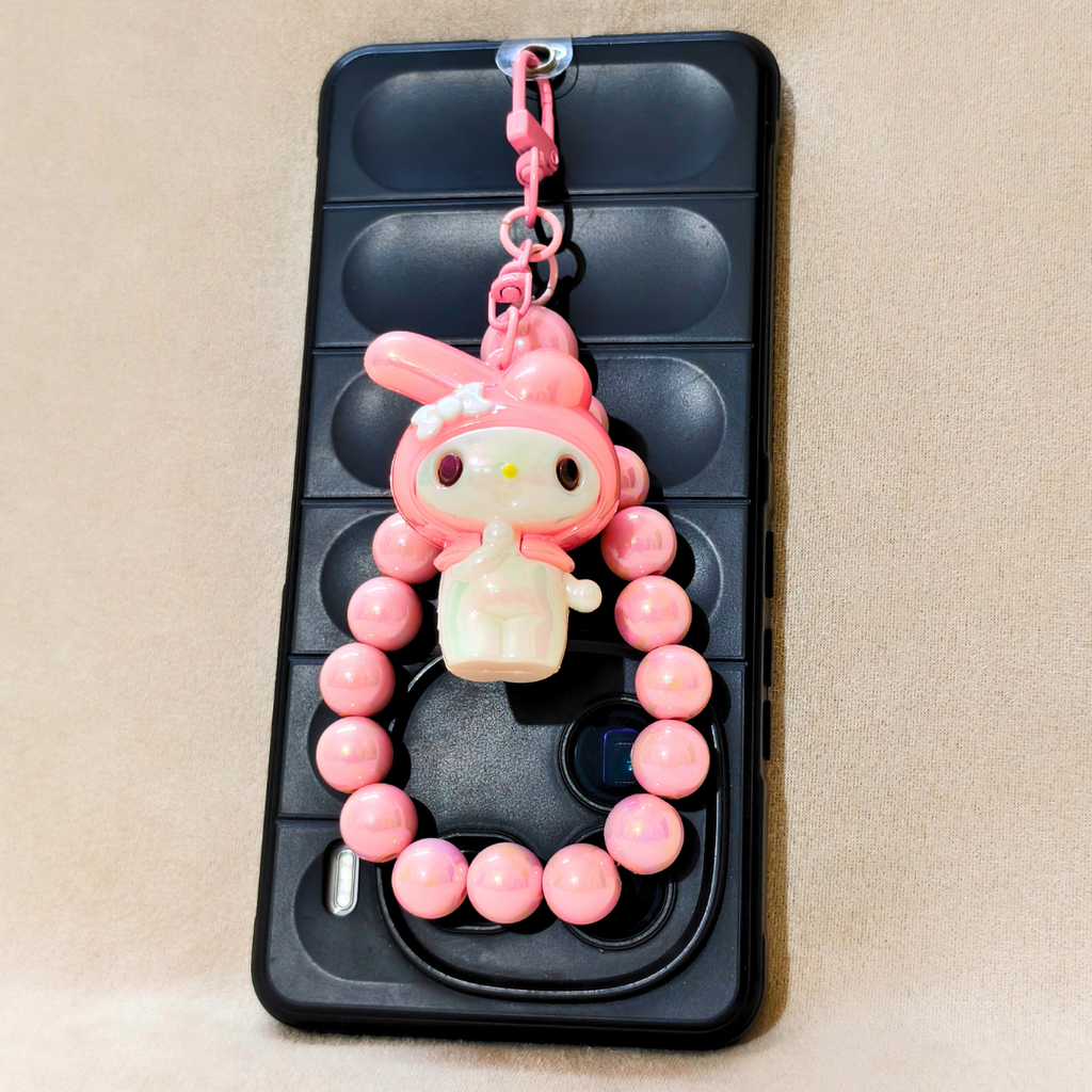 Pink character charm on a phone case with pink beads