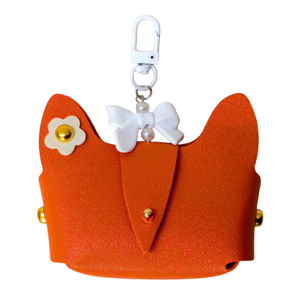 Orange cat-shaped keychain with a white bow and flower detail on a white background