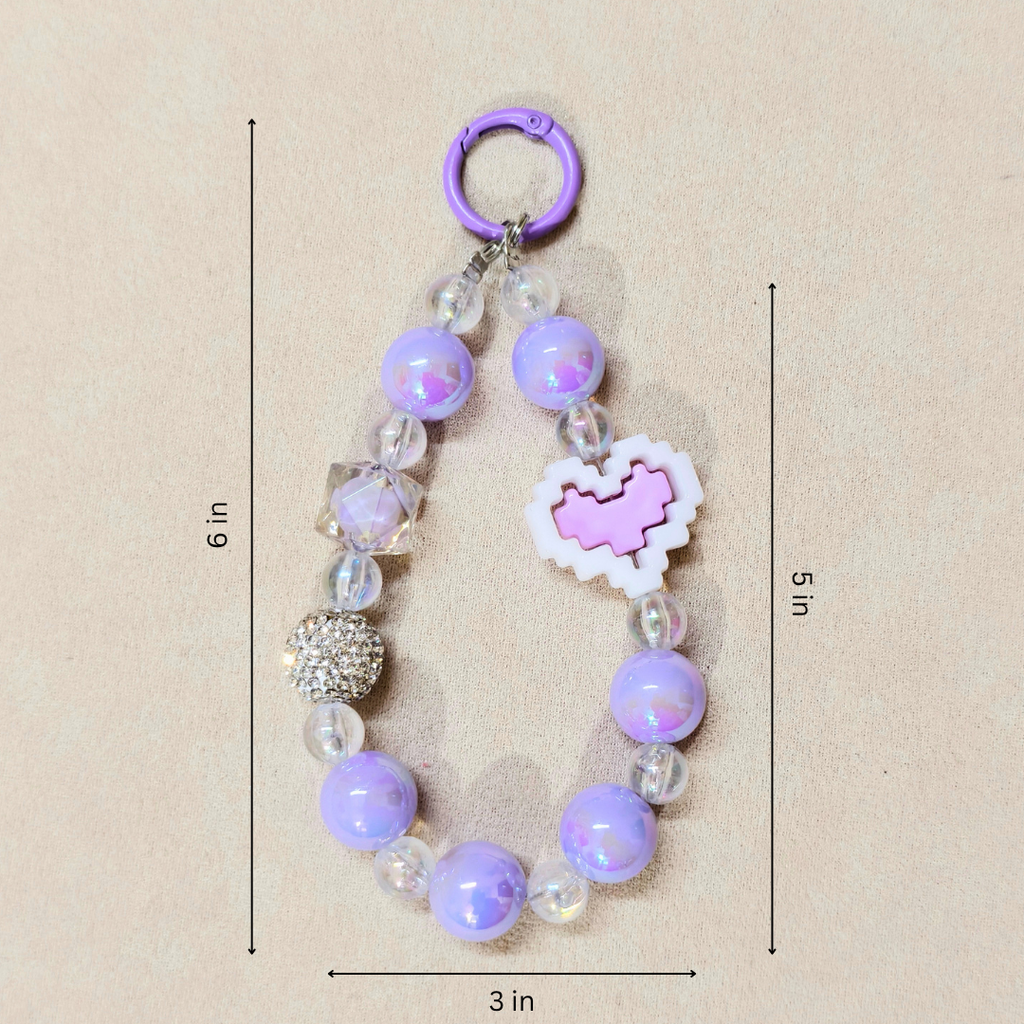 Purple beaded keychain with heart-shaped charm on a beige background