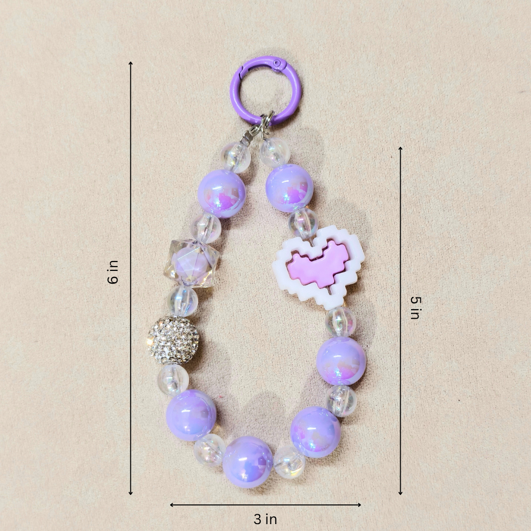 Purple beaded keychain with heart-shaped charm on a beige background