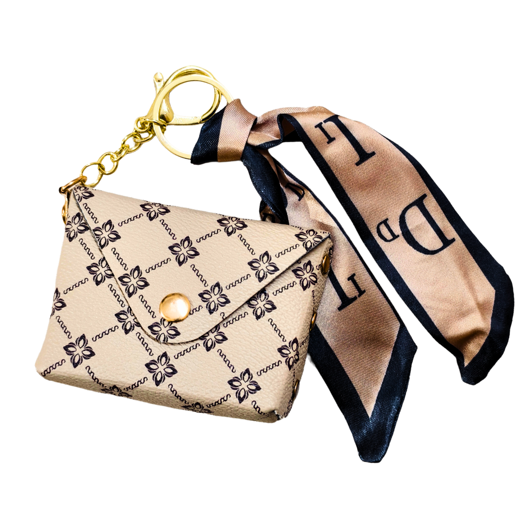 Beige handbag with floral pattern and matching scarf on a white background