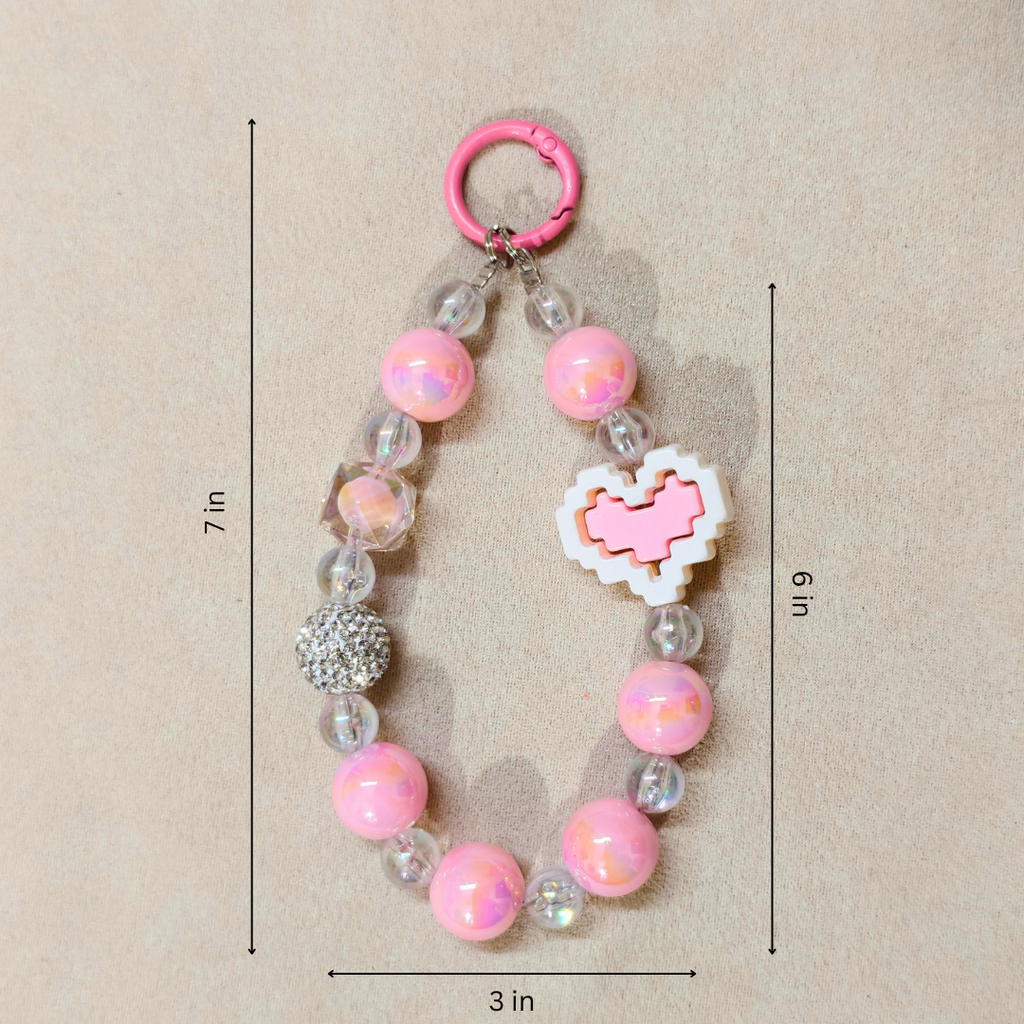 Pink beaded keychain with measurements on a beige background