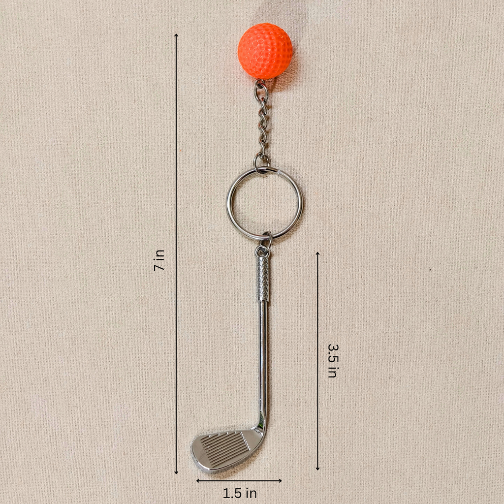 A miniature golf club keychain with an orange textured golf ball charm, showing measurements against a neutral beige background.