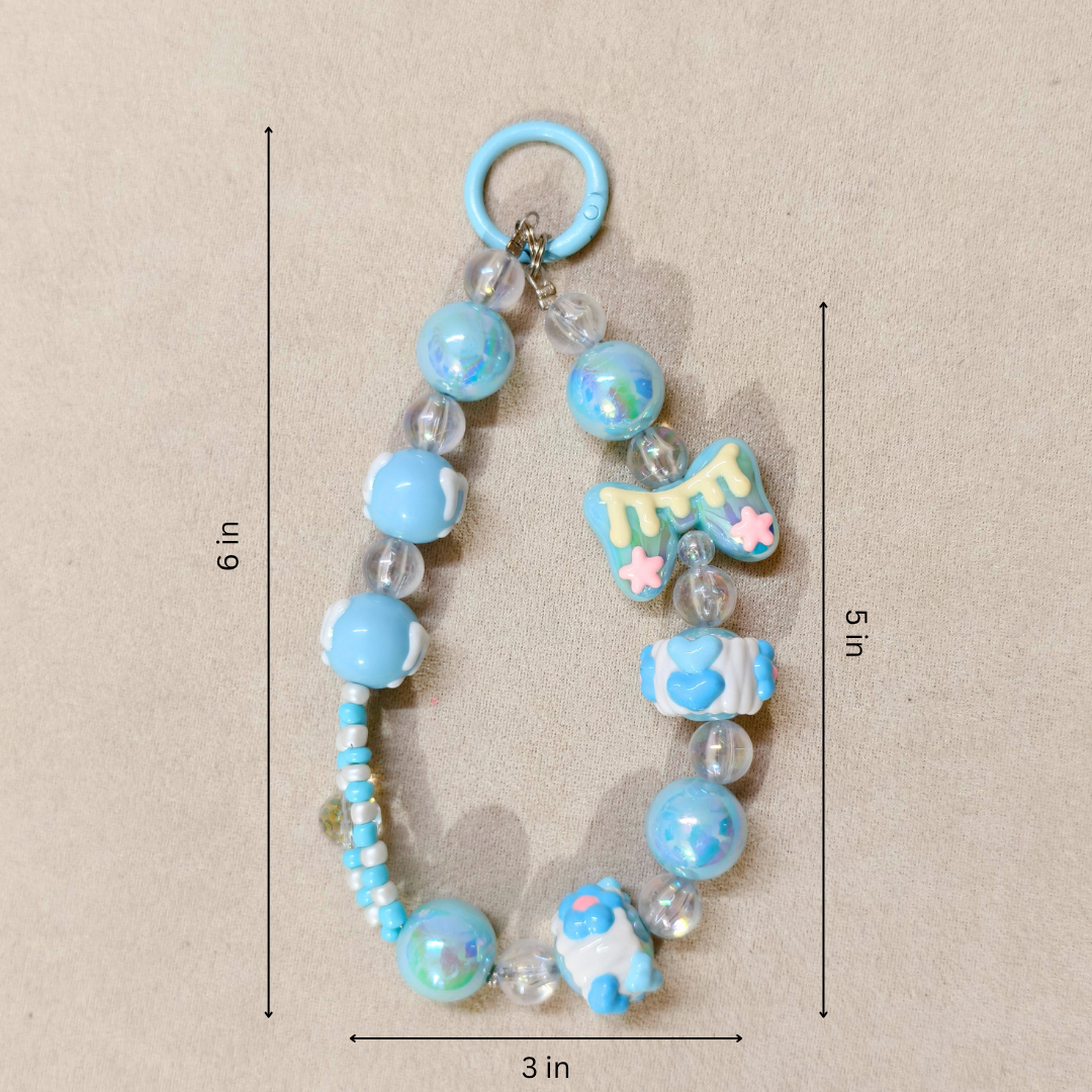 Decorative keychain with blue beads and charms on a beige background