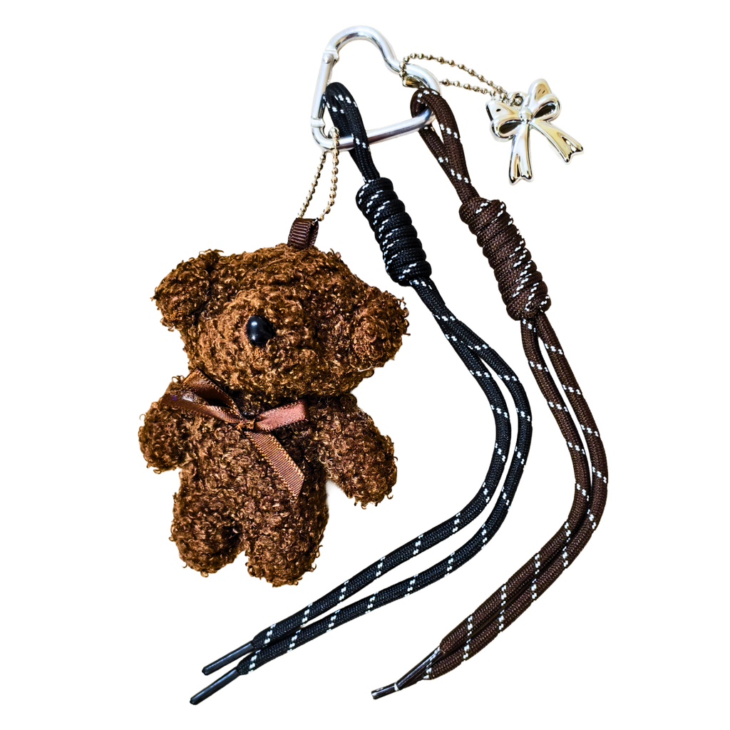 Brown teddy bear keychain with a black and brown strap on a white background