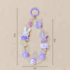 Decorative keychain with beads and charms on a beige background