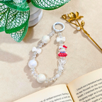 Beaded bracelet with a character charm on an open book