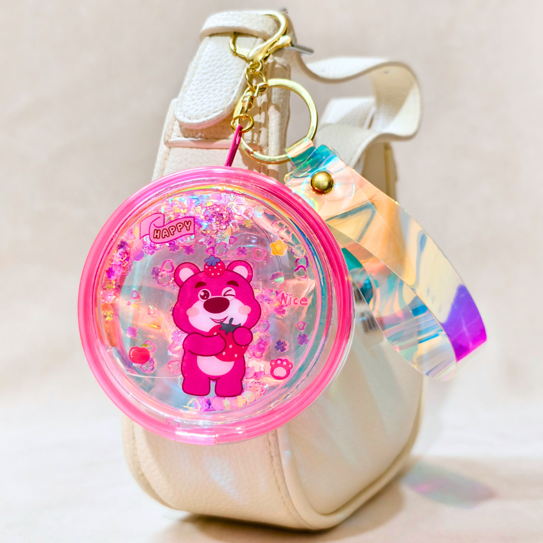 Colorful keychain with a cartoon bear design on a beige background