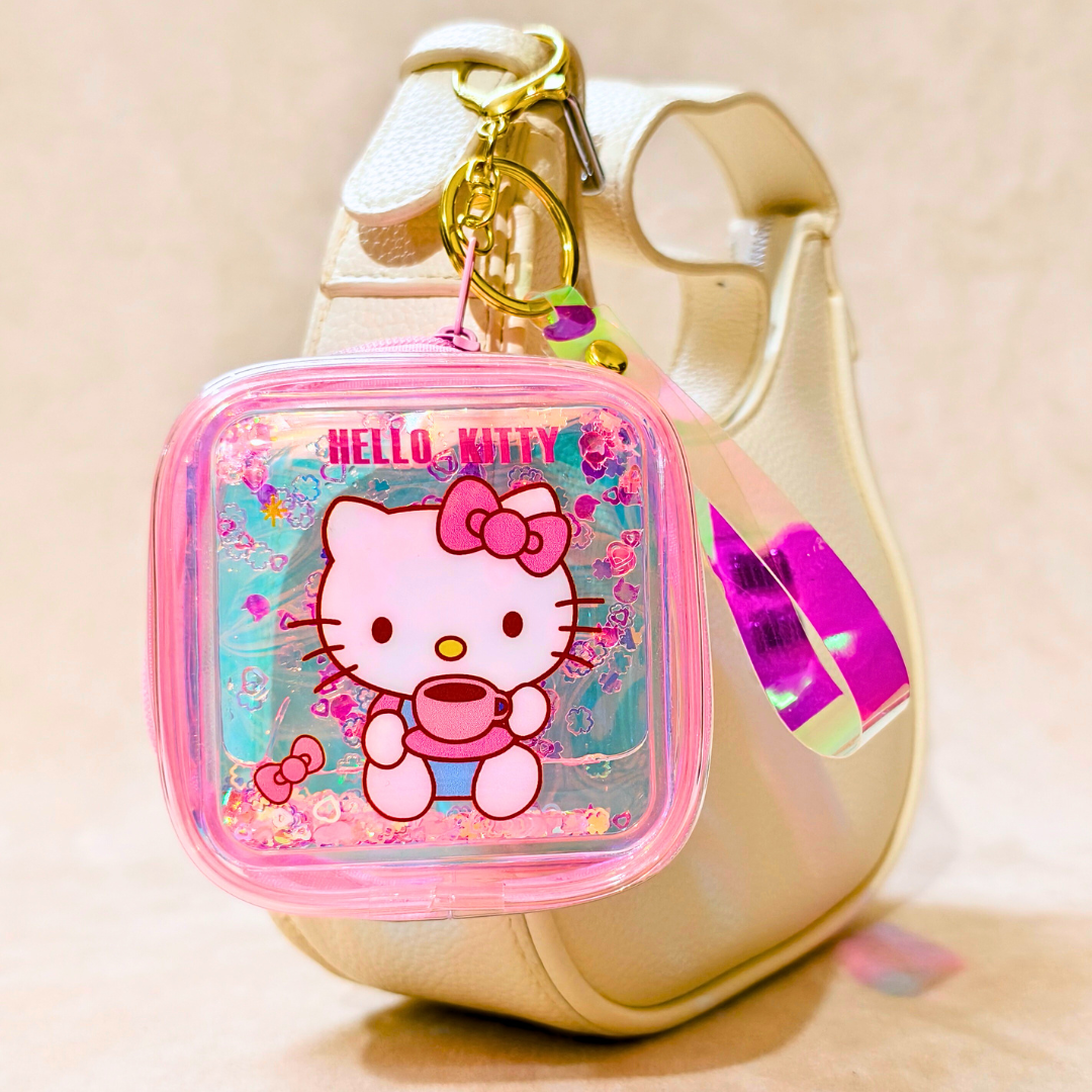 Hello Kitty keychain pouch attached to a beige handbag on a light background