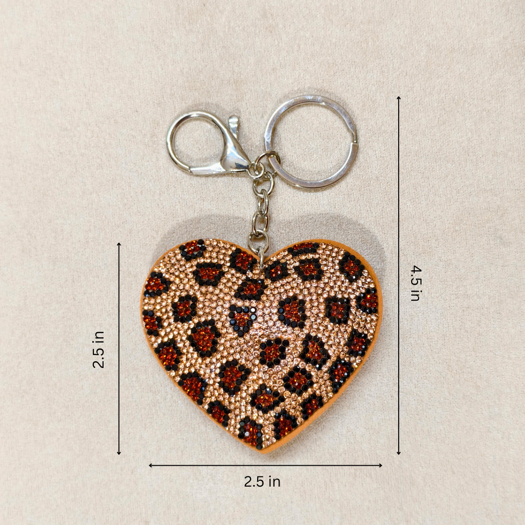 Heart-shaped keychain with leopard print pattern on a beige background