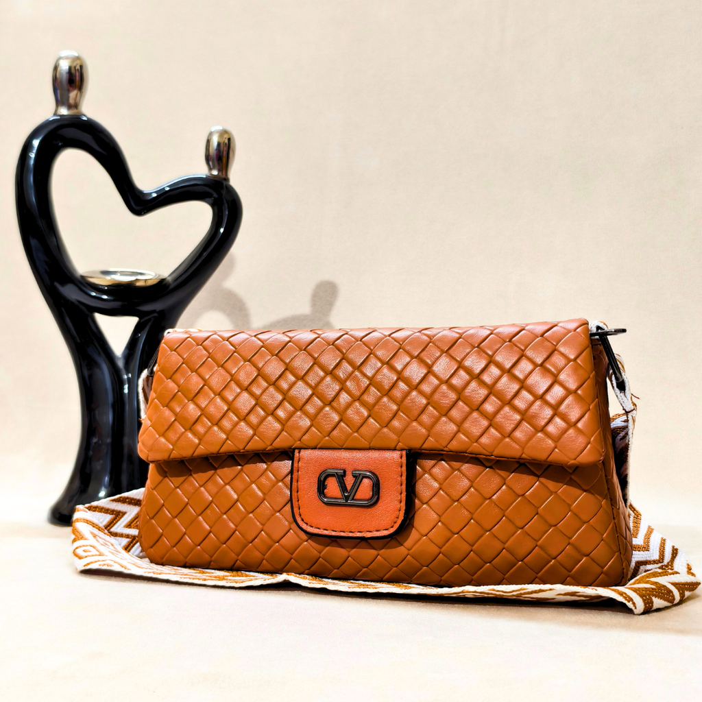 Brown woven handbag with a visible brand logo on a decorative stand with a heart design.