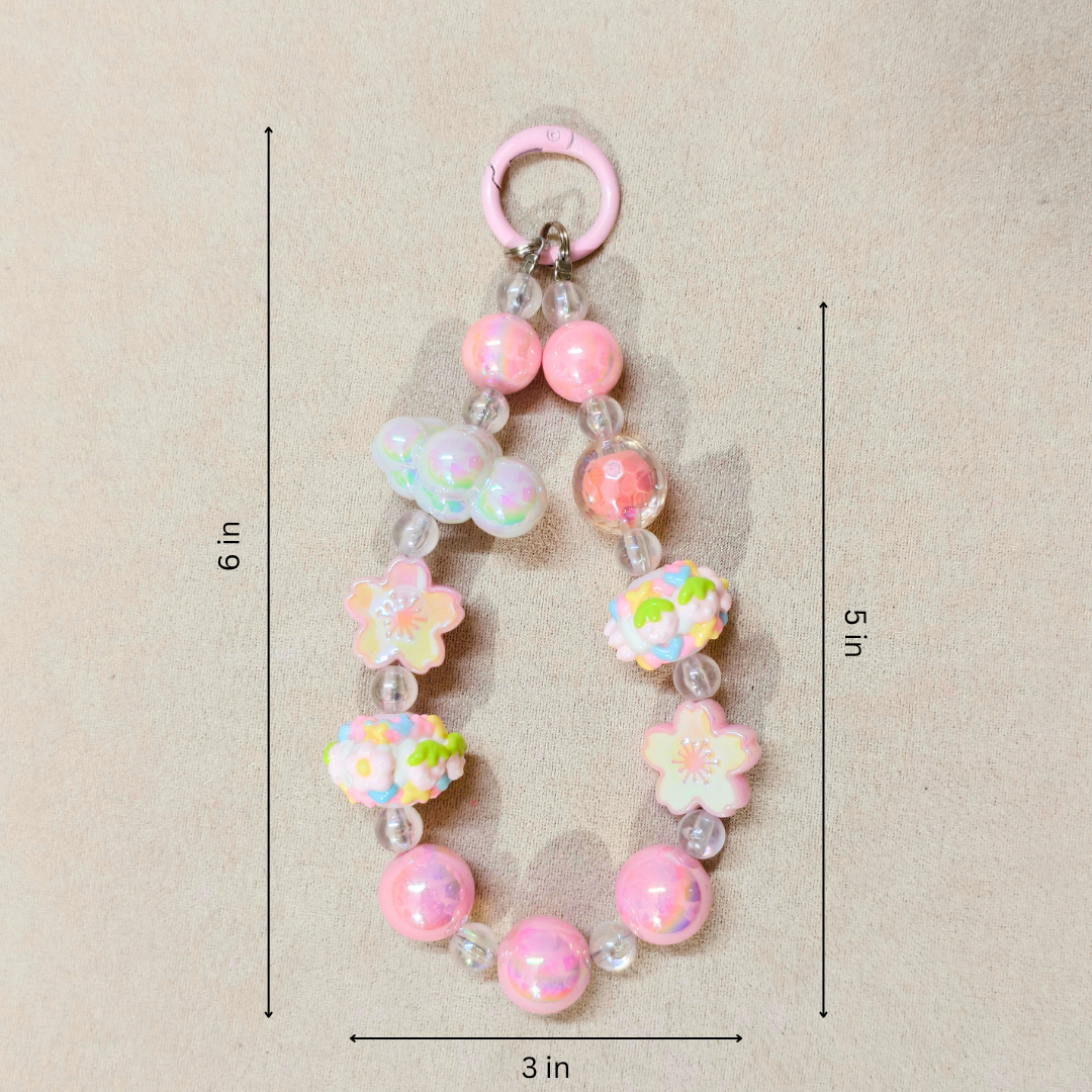 Decorative keychain with pink and multicolored beads and flowers, shown with measurements on a beige background.